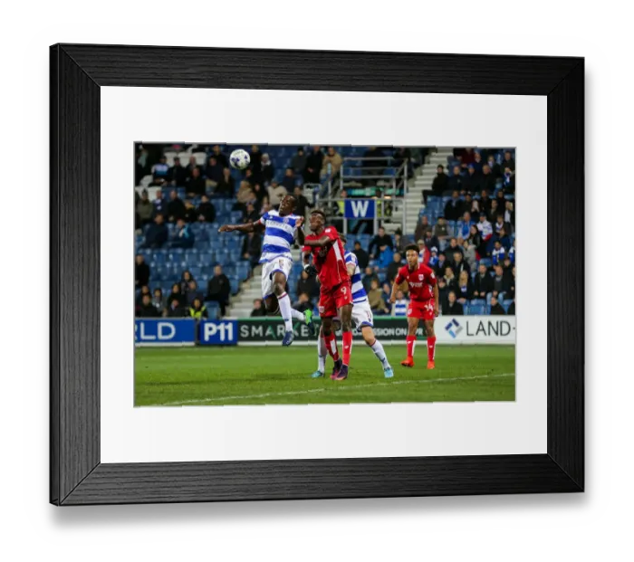 Framed Print : Clash in the Air: Onuoha vs. Abraham at Loftus Road