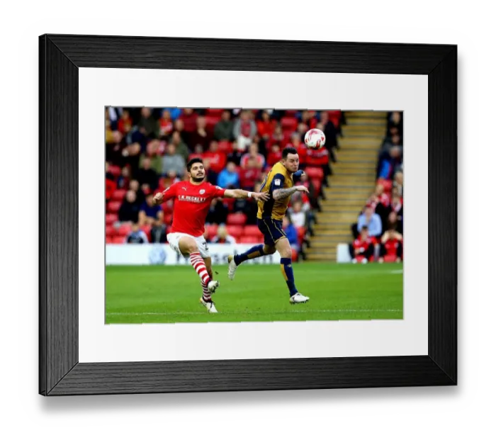 Framed Print : Bristol City's Lee Tomlin Outmuscles Barnsley's Sam Morsy for a Header at Oakwell Stadium Framed Print : Bristol City's Lee Tomlin Outmuscles Barnsley's Sam Morsy for a Header at Oakwell Stadium