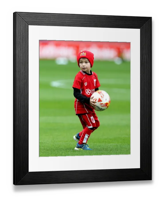 Framed Print : Young Bristol City Fan Invited onto Oakwell Pitch for Football Collection during Barnsley vs. Bristol City Match