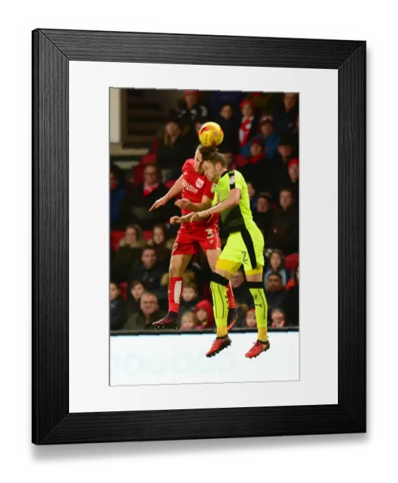 Framed Print : Intense Aerial Clash: Joe Bryan vs Chris Gunter at Ashton Gate