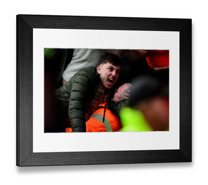 Framed Print : Exuberant Cardiff City Fan Celebrates with Steward Amidst the Thrills of Bristol City vs. Cardiff City Championship Clash