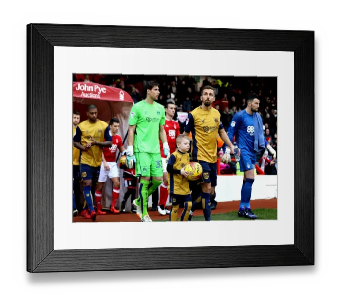 Framed Print : Gary O'Neil and Young Mascot Lead Bristol City Out at The City Ground Framed Print : Gary O'Neil and Young Mascot Lead Bristol City Out at The City Ground