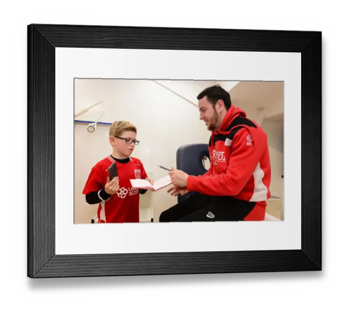 Framed Print : Bristol City's Lee Tomlin Meets and Signs for a Young Fan Before Fulham Match Framed Print : Bristol City's Lee Tomlin Meets and Signs for a Young Fan Before Fulham Match