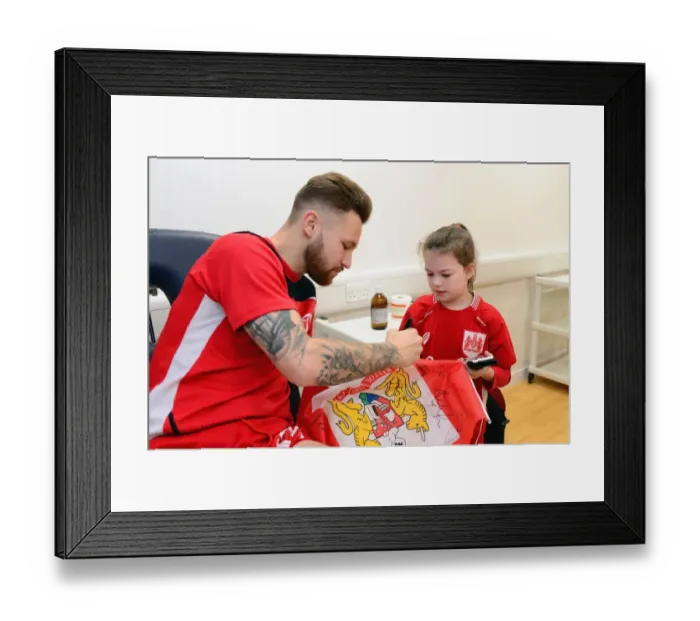 Framed Print : Bristol City's Matty Taylor Signs Autographs for Mascot Before Fulham Match Framed Print : Bristol City's Matty Taylor Signs Autographs for Mascot Before Fulham Match