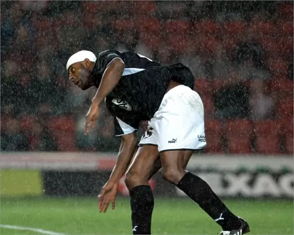 Dele Adebola challenges for the ball in the