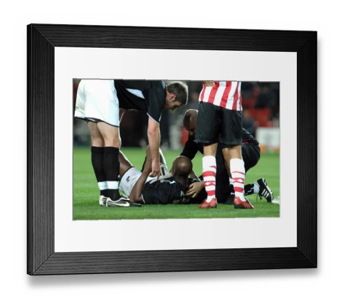 Framed Print : Dele Adebola recieves treatment for his cut Framed Print : Dele Adebola recieves treatment for his cut