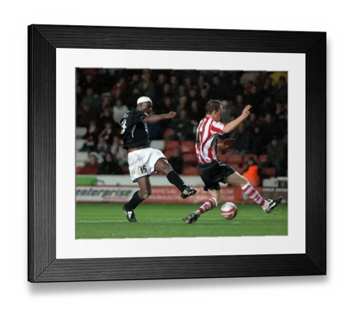 Framed Print : Dele Adebola sees his shot blocked by saints keeper kelvin davis Framed Print : Dele Adebola sees his shot blocked by saints keeper kelvin davis