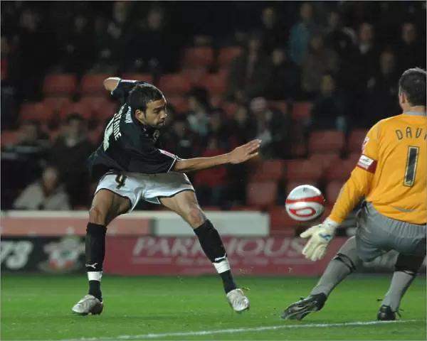 Liam Fontaine sees his shot saved by saints goalkeeper Kelvin Davies