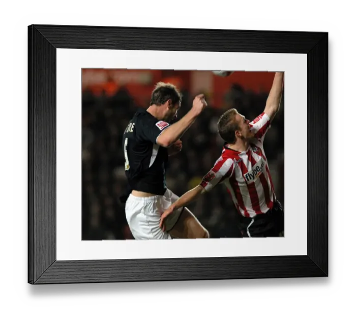 Framed Print : Jamie McCombe header is blocked by the hand of saints defender alex pearce Framed Print : Jamie McCombe header is blocked by the hand of saints defender alex pearce
