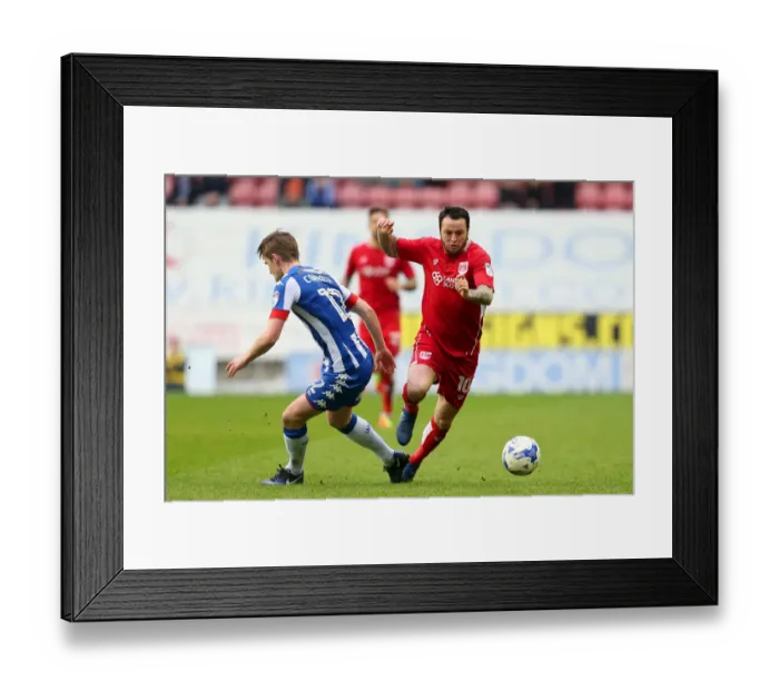 Framed Print : Bristol City's Lee Tomlin Faces Off Against Wigan Athletic's Callum Connolly in Championship Clash