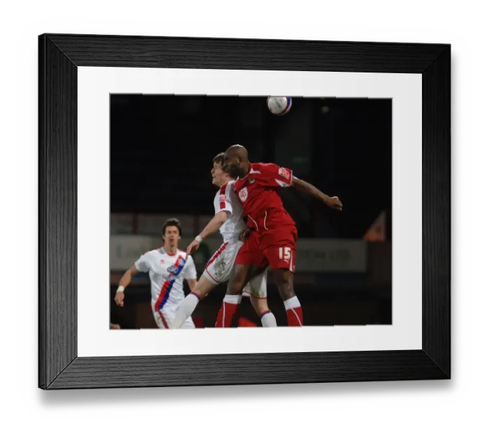 Framed Print : Dele Adebola flicks the ball on ahead of Paddy McCarthy