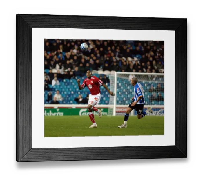 Framed Print : Marvin Elliott chases for the ball along with Jimmy Smith