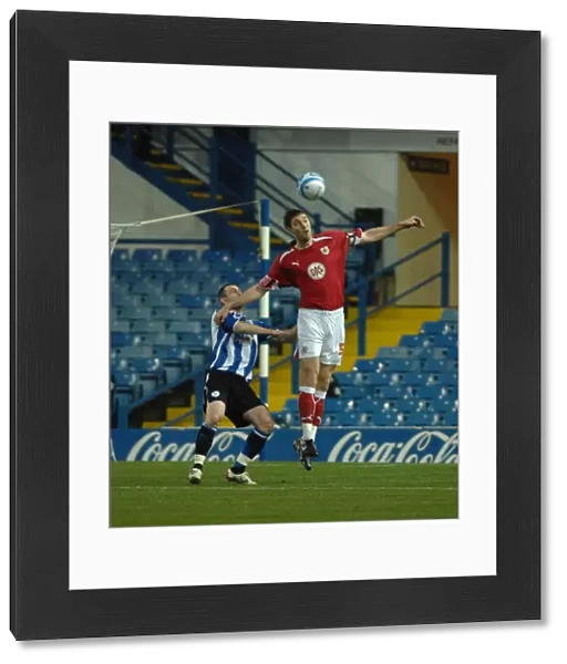 Jamie McCombe climes above the sheffield wednesday front line