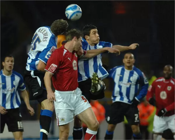 Jamie McCombe jumps to compete with the sheffield wednesday defence