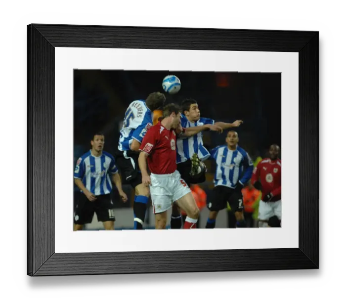 Framed Print : Jamie McCombe jumps to compete with the sheffield wednesday defence Framed Print : Jamie McCombe jumps to compete with the sheffield wednesday defence