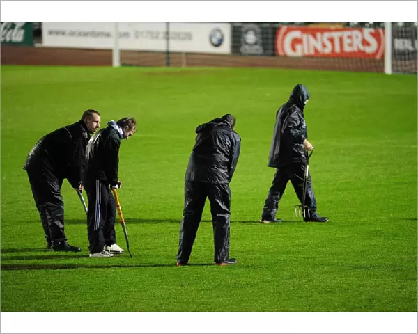 Groundsman work hard to make sure the pitch is playable