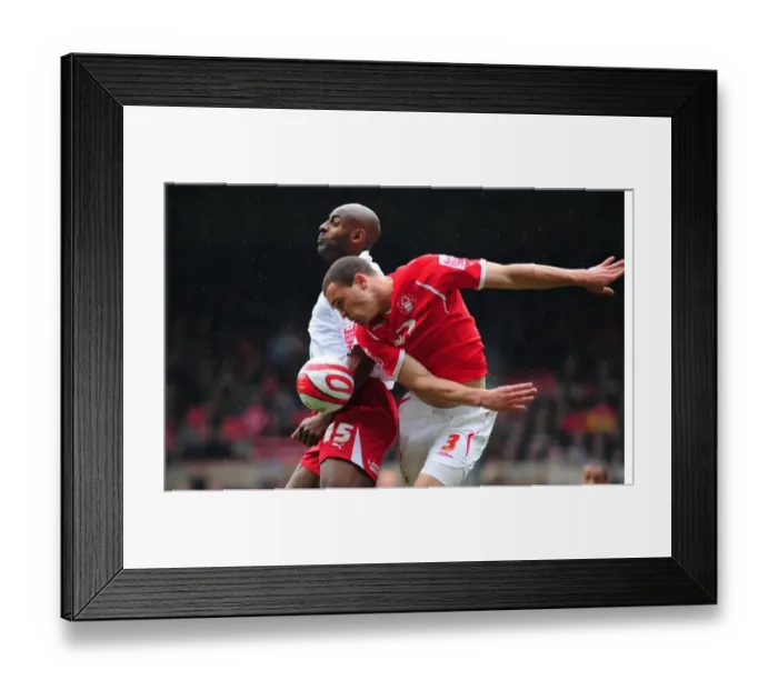 Framed Print : Dele Adebola jumps with Joel Lynch