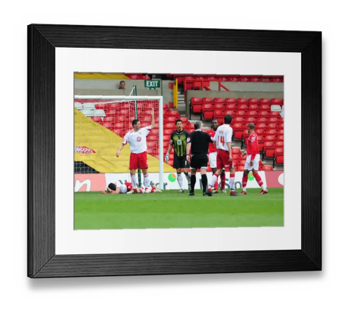 Framed Print : Bradley Orr calls the physio on for the injures Liam Fontaine