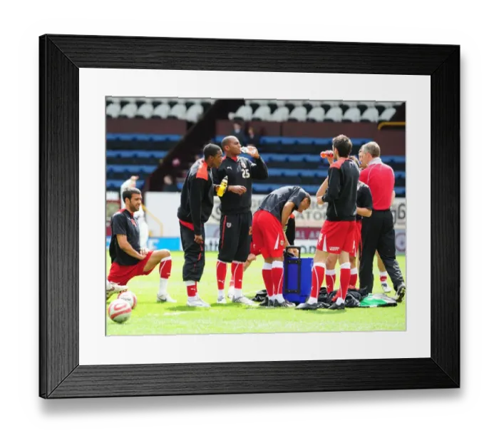 Framed Print : City players take a break during warm up Framed Print : City players take a break during warm up