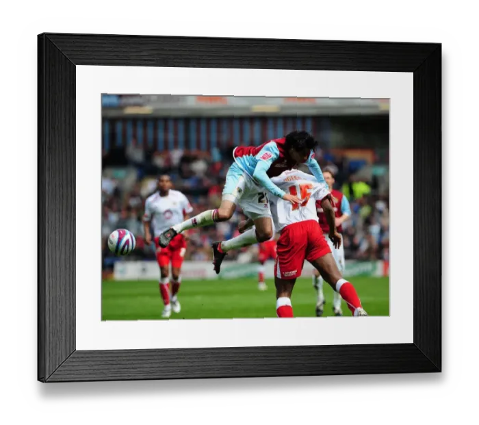 Framed Print : Rhys Williams climbs over Dele Adebola