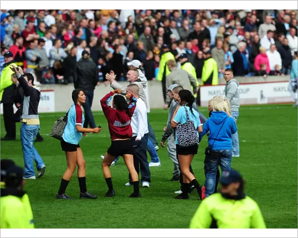 Burnley fans on the pitch