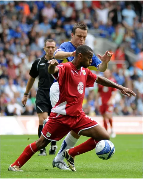 Bristol City`s Danny Haynes and Cardiff`s Gavin Rae battle for possession