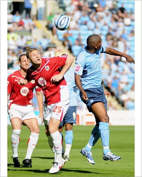 Brian Wilson heads clear from Coventry`s Clinton Morrison