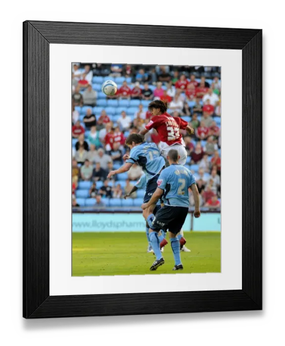 Framed Print : Alvaro Saborio climbs above the Coventry