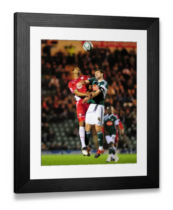 Framed Print : Bristol City's Marvin Elliott vs. Plymouth Argyle's Carl Fletcher: Aerial Battle in Championship Match, March 2010 Framed Print : Bristol City's Marvin Elliott vs. Plymouth Argyle's Carl Fletcher: Aerial Battle in Championship Match, March 2010
