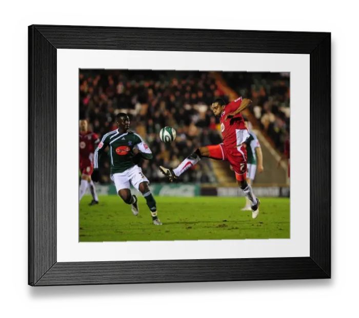 Framed Print : Battling for Supremacy: Marvin Elliott vs. Yannick Bolasie in the Championship Clash between Plymouth Argyle and Bristol City (16-03-2010) Framed Print : Battling for Supremacy: Marvin Elliott vs. Yannick Bolasie in the Championship Clash between Plymouth Argyle and Bristol City (16-03-2010)