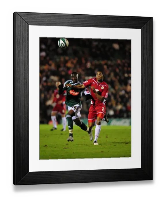 Framed Print : Battling for Control: Marvin Elliott vs. Yannick Bolasie in the Intense Championship Showdown between Plymouth Argyle and Bristol City (16 / 03 / 2010)