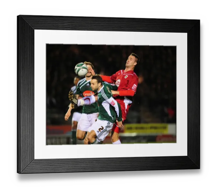 Framed Print : Clash in the Championship: Stefan Maierhofer of Bristol City Battles Karl Duguid of Plymouth Argyle for an Aerial Ball