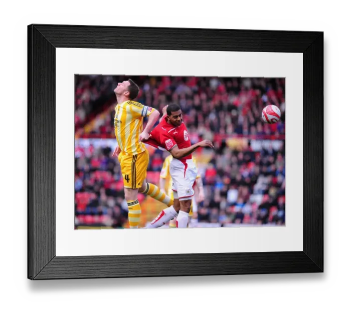 Framed Print : Bristol City's Marvin Elliott vs. Newcastle United's Kevin Nolan: Aerial Battle in the Championship (20 / 03 / 2010)