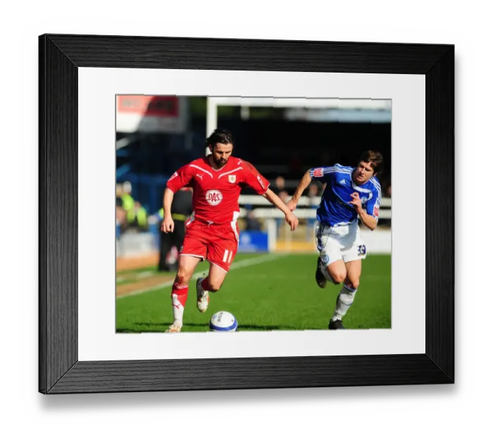 Framed Print : Battling for Supremacy: Hartley vs. Simpson in the Championship Clash between Peterborough and Bristol City