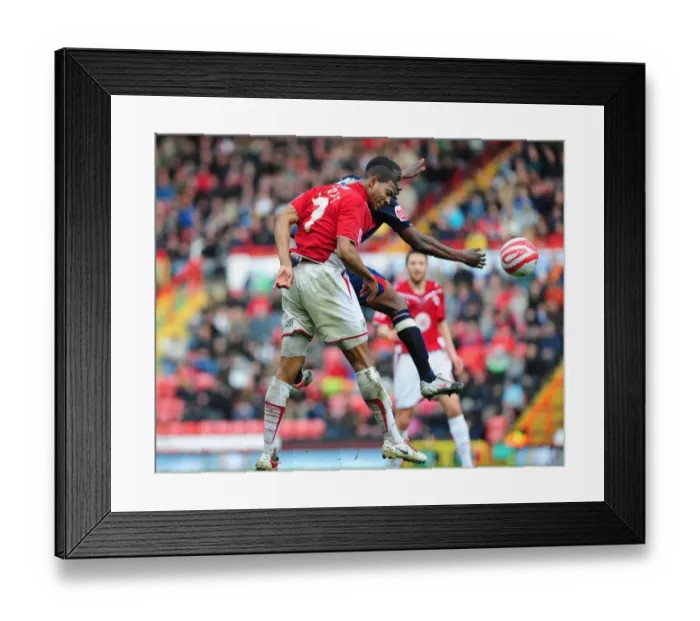 Framed Print : Clash in the Sky: Marvin Elliott vs. Guy Moussi - Bristol City vs. Nottingham Forest, Championship, 03 / 04 / 2010