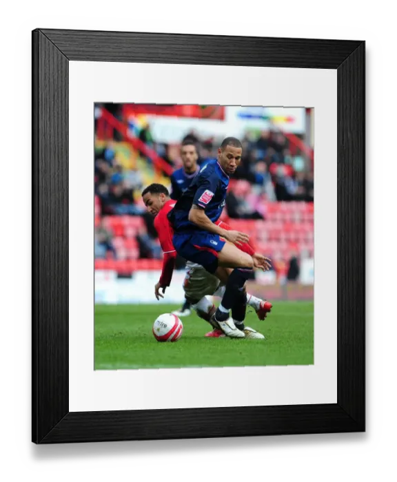 Framed Print : Nicky Maynard Slips Past Kelvin Wilson: A Pivotal Moment in the 2010 Championship Clash Between Bristol City and Nottingham Forest