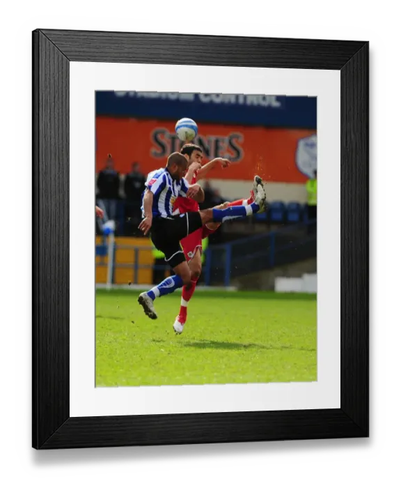 Framed Print : Challenging Heights: Tudgay vs. Fontaine in the Championship Clash between Sheffield Wednesday and Bristol City (16th March 2010)