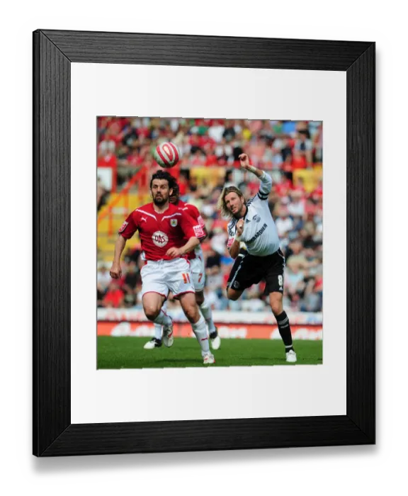Framed Print : Clash at Ashton Gate: Robbie Savage vs. Paul Hartley Battle for Aerial Supremacy - Derby County vs. Bristol City, Championship 2010 Framed Print : Clash at Ashton Gate: Robbie Savage vs. Paul Hartley Battle for Aerial Supremacy - Derby County vs. Bristol City, Championship 2010