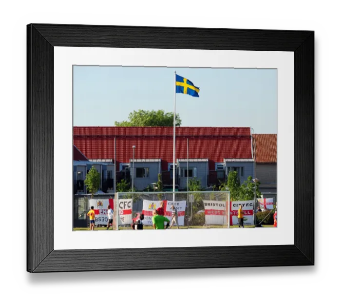 Framed Print : Bristol City fans decorate the ground with flags below the Swedish flag