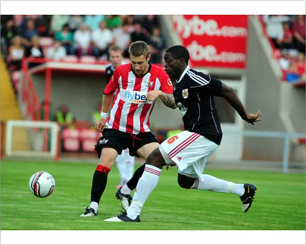 David Noble is tackled by Bristol Citys John Akinde