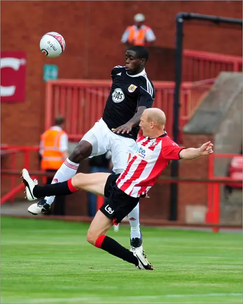 Bristol Citys John Akinde battles for the ball with Rob Edwards