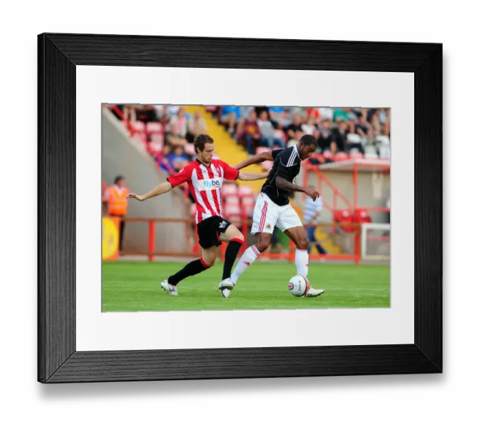 Framed Print : Bristol Citys Marvin Elliott battles for the ball with Ryan Harley