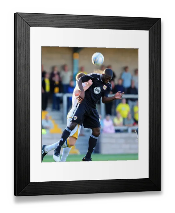 Framed Print : Bristol Citys John Akinde challenges for the ariel ball