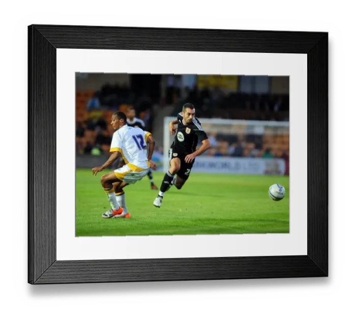 Framed Print : Bristol Citys trialist Tom Williams goes past the torquay defence