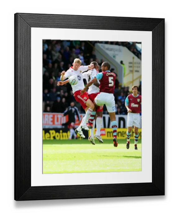 Framed Print : Clash at Turf Moor: Stead and Elliott Battle for Aerial Supremacy against Burnley's Carlisle Framed Print : Clash at Turf Moor: Stead and Elliott Battle for Aerial Supremacy against Burnley's Carlisle