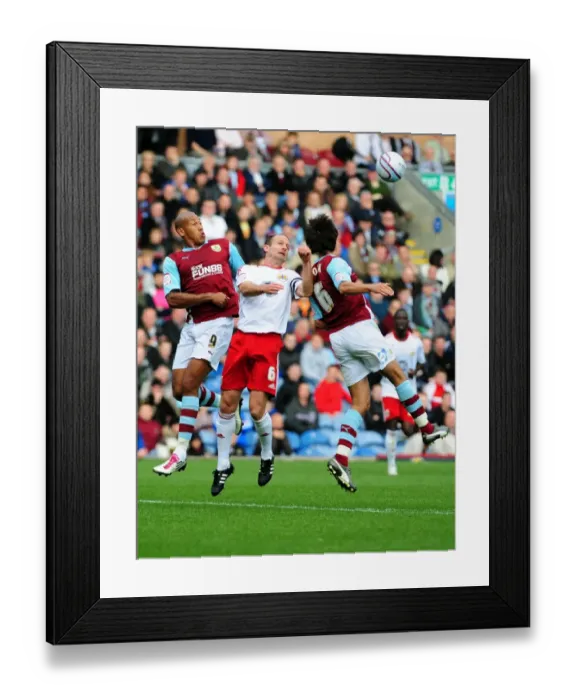 Framed Print : Bristol City's Louis Carey Battles for Aerial Ball Against Burnley's Iwelumo and Cork in Championship Match, 2010 Framed Print : Bristol City's Louis Carey Battles for Aerial Ball Against Burnley's Iwelumo and Cork in Championship Match, 2010