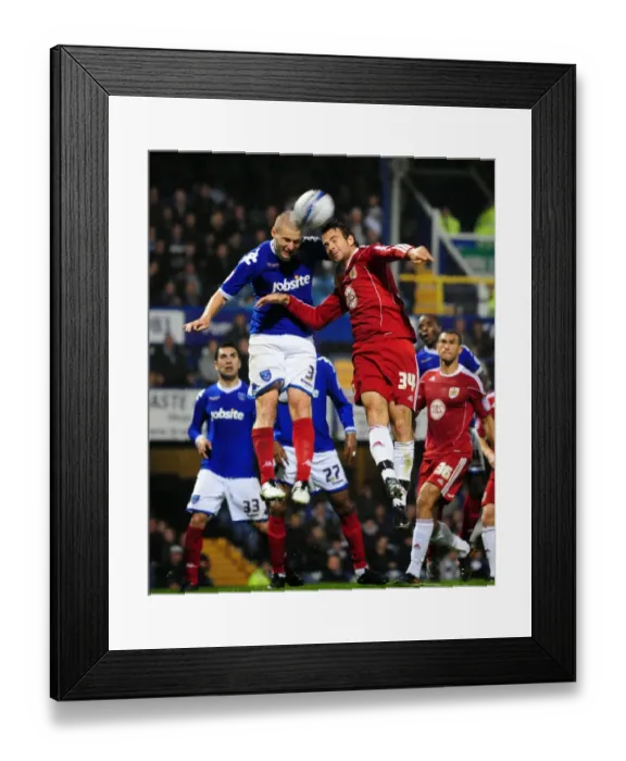 Framed Print : Clash at Fratton Park: Dickinson vs. Pitman Battle for Aerial Supremacy in Portsmouth vs. Bristol City Championship Clash (September 2010)