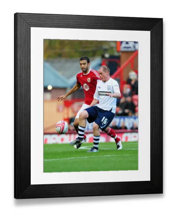 Framed Print : Battling for Supremacy: Liam Fontaine vs. Iain Hume in the Championship Clash between Bristol City and Preston North End
