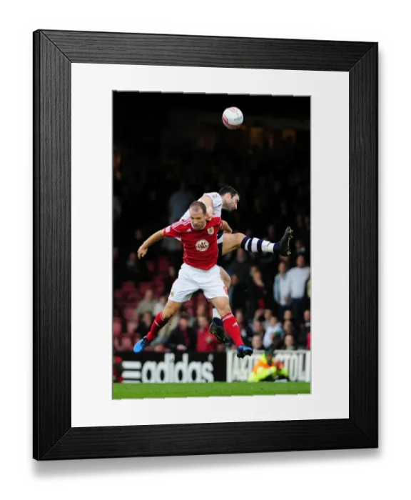 Framed Print : Clash in the Air: Craig Morgan Outjumps Louis Carey in Championship Showdown - Bristol City vs Preston North End (06 / 11 / 2010)