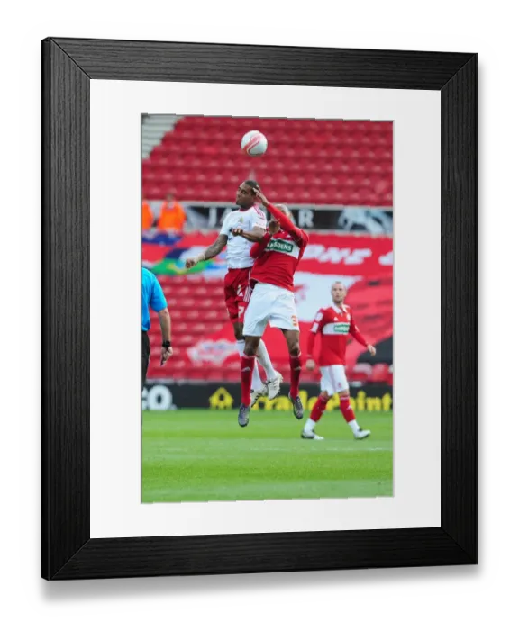 Framed Print : Bristol Citys Marvin Elliott battles for the ball in the air with Middlesbroughs Mickael Tavares